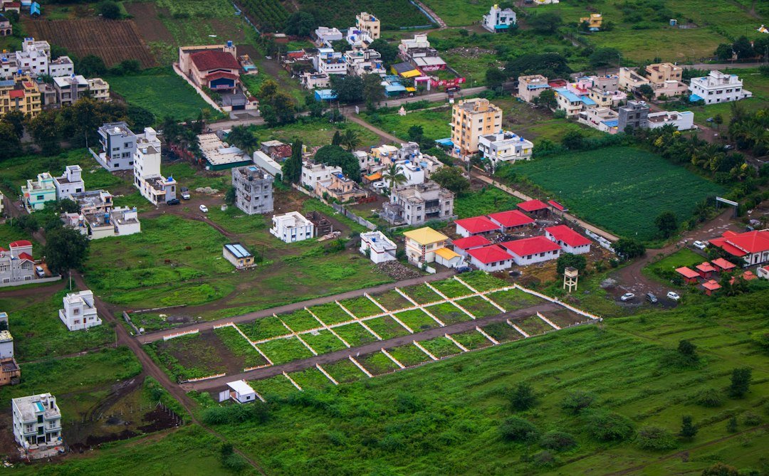 Aerial view of a residential area with houses and plots